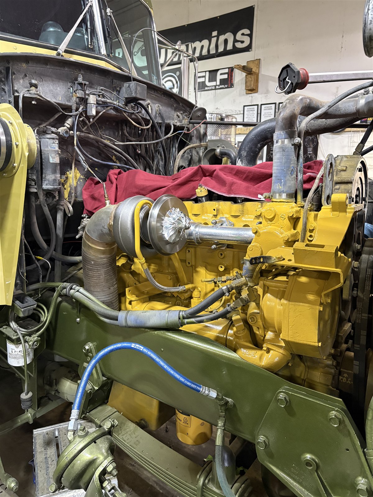 Rebuilt yellow diesel engine and turbo installed inside the Hess service bay